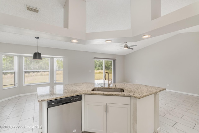 kitchen with stainless steel dishwasher, a sink, visible vents, white cabinetry, and light stone counters