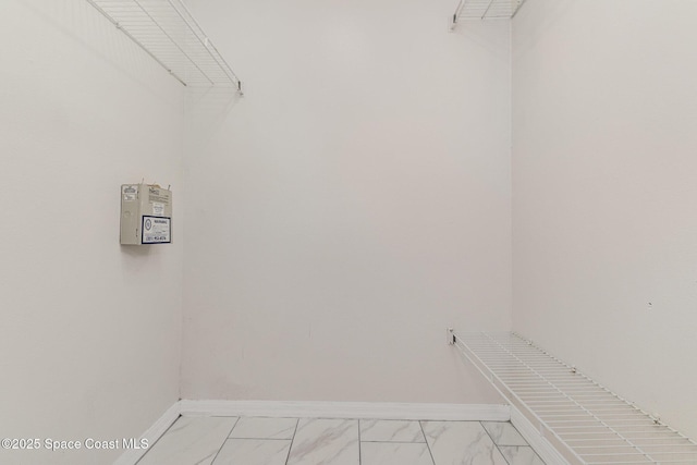 spacious closet featuring marble finish floor