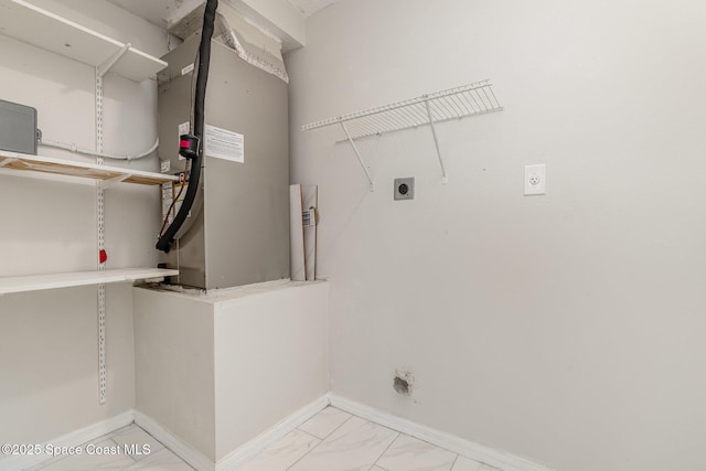 laundry area with electric dryer hookup, baseboards, marble finish floor, and laundry area