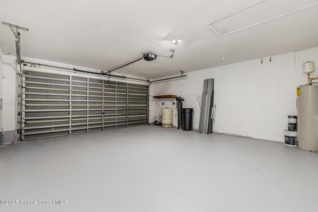 garage with concrete block wall, water heater, and a garage door opener