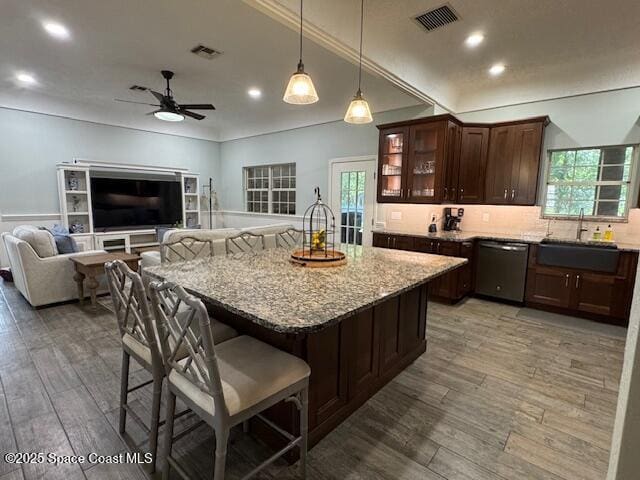 572 Lake Ashley Cir, Melbourne, FL 32904 - kitchen with dishwasher, a sink, light stone counters, a ceiling fan, and recessed lighting