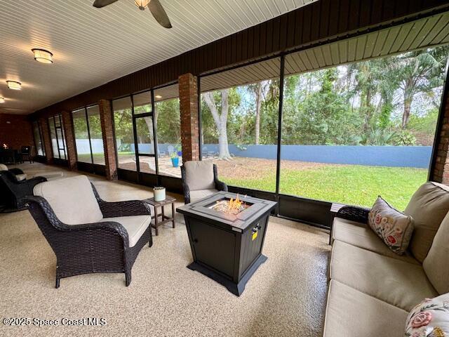 572 Lake Ashley Cir, Melbourne, FL 32904 - sunroom / solarium with a ceiling fan and an outdoor living space with a fire pit