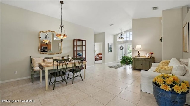 dining area featuring baseboards, high vaulted ceiling, and light tile patterned floors