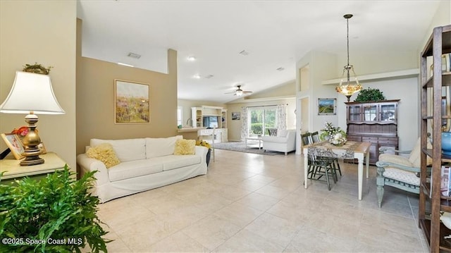 living room with lofted ceiling, visible vents, light tile patterned floors, and a ceiling fan