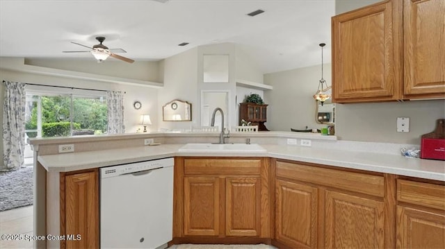 kitchen with light countertops, a peninsula, ceiling fan, a sink, and white dishwasher
