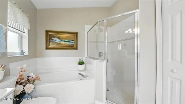 full bathroom with a shower stall, toilet, and a garden tub