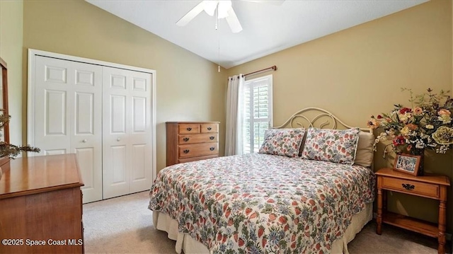bedroom featuring a closet, lofted ceiling, ceiling fan, and carpet floors