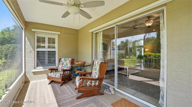 sunroom featuring a ceiling fan