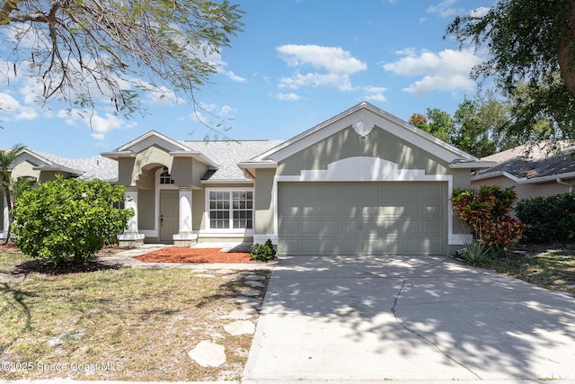 single story home featuring an attached garage, a shingled roof, stucco siding, and concrete driveway