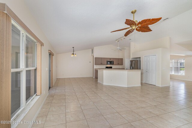 unfurnished living room with light tile patterned flooring, visible vents, baseboards, ceiling fan, and high vaulted ceiling