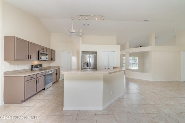 kitchen with high vaulted ceiling, ceiling fan, appliances with stainless steel finishes, and light tile patterned floors