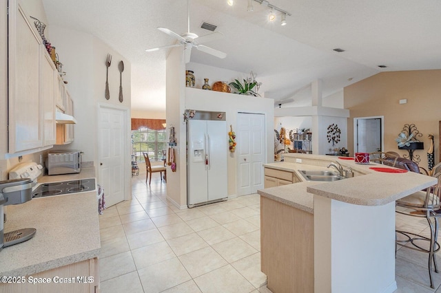6109 Meghan Dr, Melbourne, FL 32940 - kitchen with white fridge with ice dispenser, a ceiling fan, a sink, light countertops, and light tile patterned floors