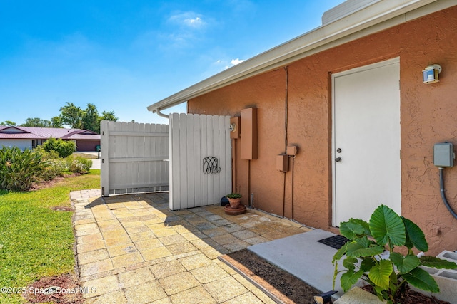 3210 Calgary St, Melbourne, FL 32935 - property entrance with a patio area and stucco siding