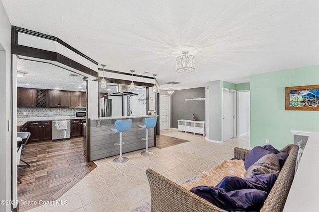 3210 Calgary St, Melbourne, FL 32935 - living area featuring a chandelier, light tile patterned floors, visible vents, and a textured ceiling