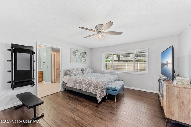 3210 Calgary St, Melbourne, FL 32935 - bedroom with baseboards, a ceiling fan, a textured ceiling, connected bathroom, and wood finished floors