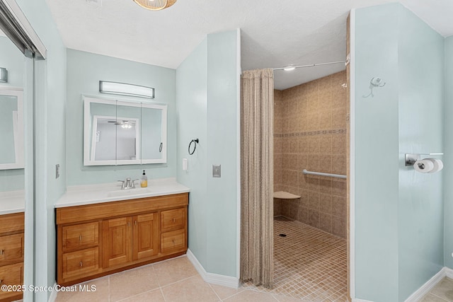 3210 Calgary St, Melbourne, FL 32935 - bathroom featuring a tile shower, tile patterned floors, vanity, and baseboards
