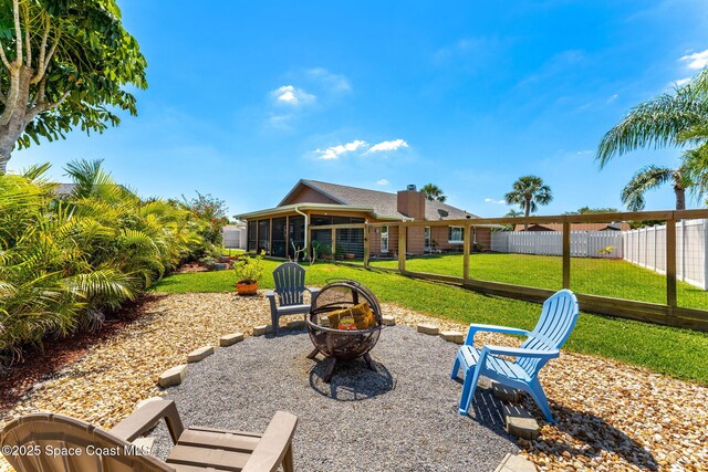 3210 Calgary St, Melbourne, FL 32935 - exterior space featuring fence, a fire pit, and a sunroom