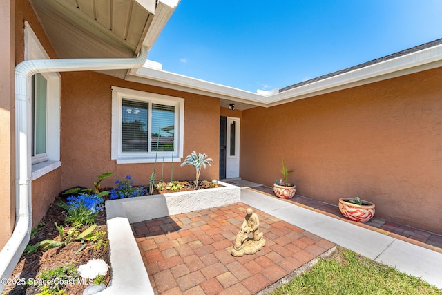 3210 Calgary St, Melbourne, FL 32935 - doorway to property with a patio area and stucco siding