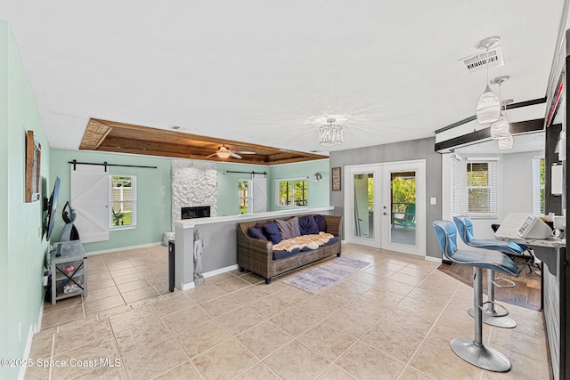3210 Calgary St, Melbourne, FL 32935 - interior space with light tile patterned floors, baseboards, ceiling fan, a fireplace, and french doors