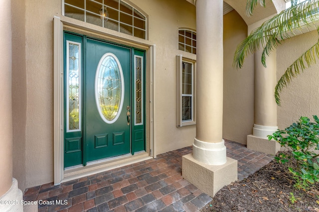 entrance to property with stucco siding