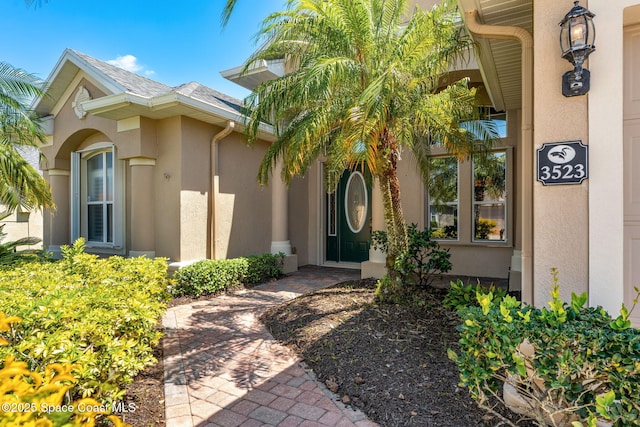entrance to property featuring stucco siding