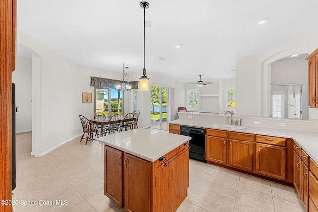 kitchen featuring arched walkways, dishwasher, light countertops, and a sink