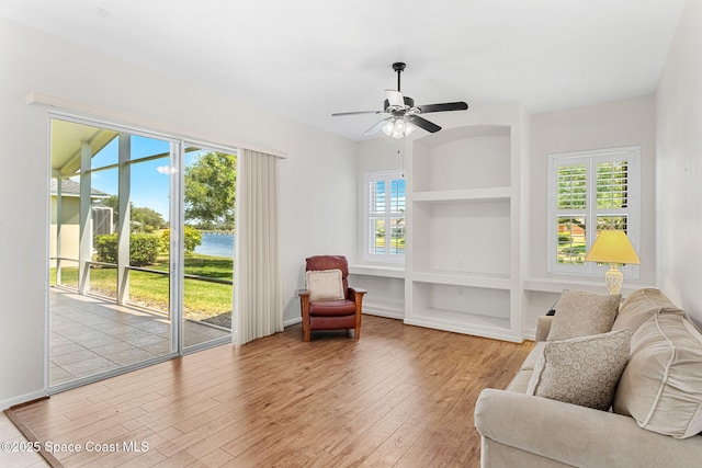 living area featuring hardwood / wood-style floors, ceiling fan, and a wealth of natural light