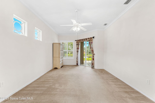 unfurnished room featuring ceiling fan, baseboards, ornamental molding, and light carpet