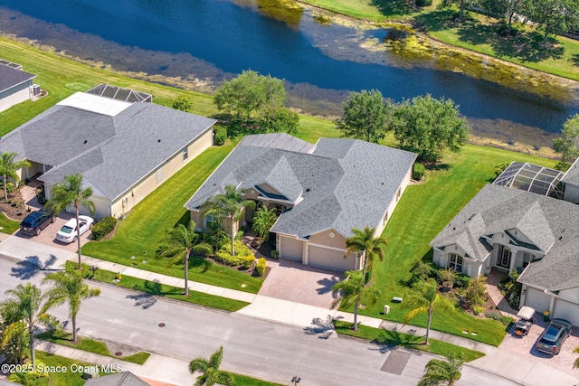 birds eye view of property with a water view and a residential view
