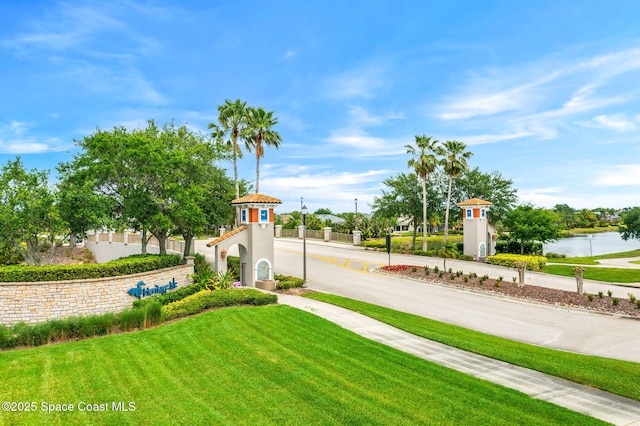 exterior space featuring sidewalks and a water view