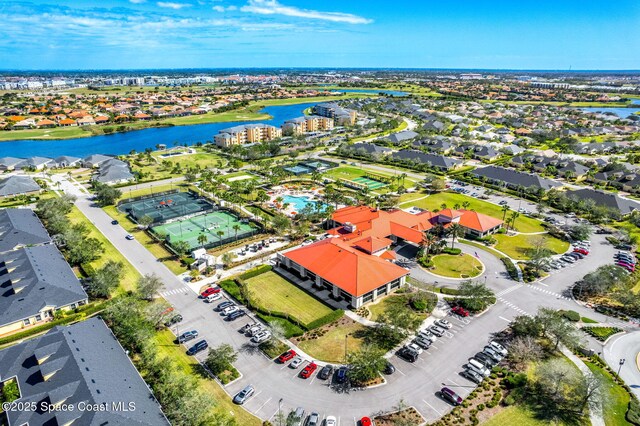 drone / aerial view with a water view and a residential view