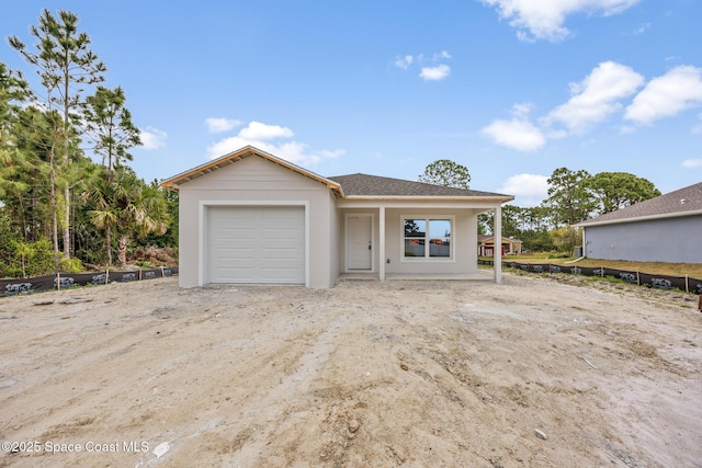 view of front of home with stucco siding and a garage