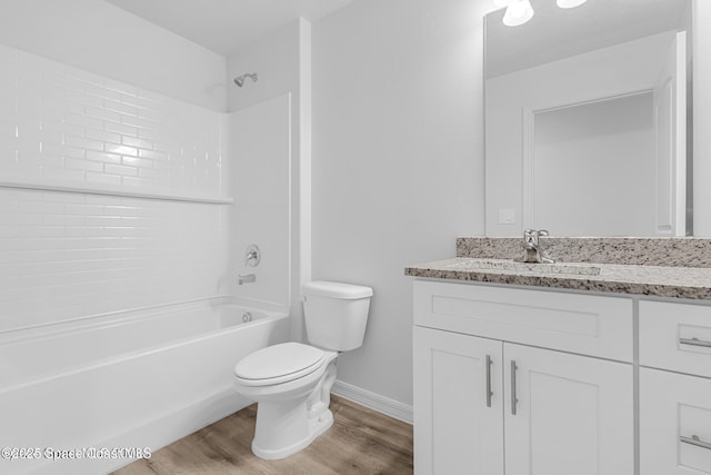 full bathroom featuring baseboards, toilet, wood finished floors, vanity, and  shower combination
