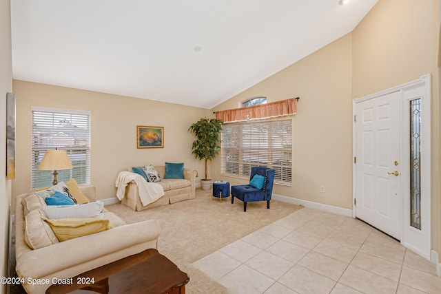 2842 Galindo Cir, Melbourne, FL 32940 - living area featuring baseboards, high vaulted ceiling, light carpet, and plenty of natural light