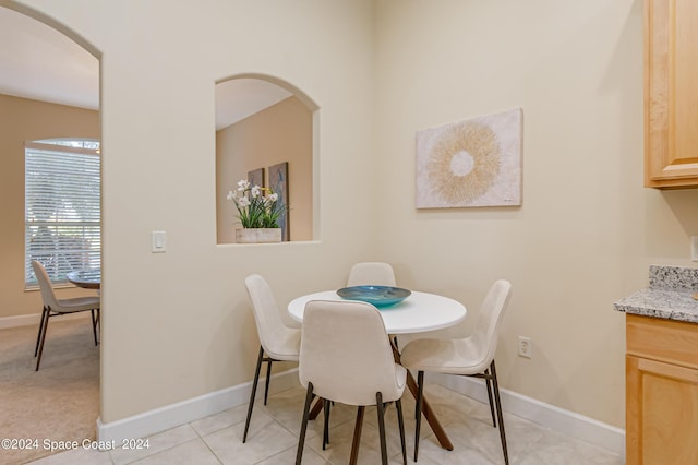2842 Galindo Cir, Melbourne, FL 32940 - dining room with light tile patterned floors, arched walkways, and baseboards