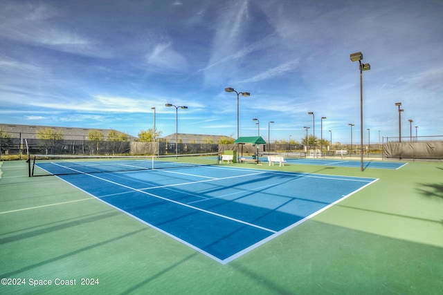 2842 Galindo Cir, Melbourne, FL 32940 - view of tennis court with community basketball court and fence