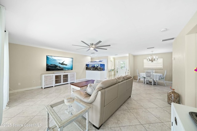 1117 Cheyenne Dr, Indian Harbour Beach, FL 32937 - living area featuring light tile patterned flooring, ceiling fan with notable chandelier, baseboards, and visible vents