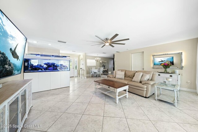 1117 Cheyenne Dr, Indian Harbour Beach, FL 32937 - living area with light tile patterned flooring, baseboards, visible vents, and ceiling fan with notable chandelier