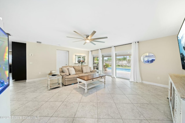 1117 Cheyenne Dr, Indian Harbour Beach, FL 32937 - living area with baseboards, ceiling fan, and light tile patterned floors