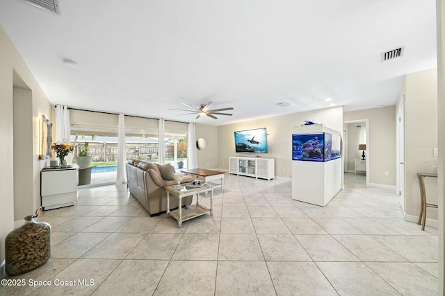 1117 Cheyenne Dr, Indian Harbour Beach, FL 32937 - living area featuring baseboards, ceiling fan, visible vents, and light tile patterned floors
