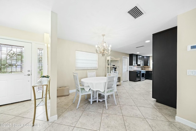 1117 Cheyenne Dr, Indian Harbour Beach, FL 32937 - dining space with baseboards, visible vents, an inviting chandelier, and light tile patterned floors