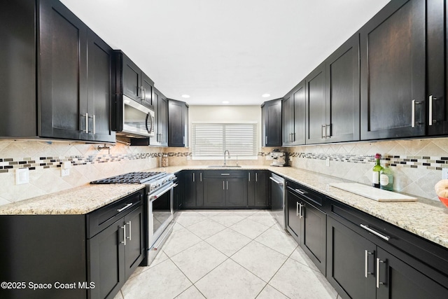 1117 Cheyenne Dr, Indian Harbour Beach, FL 32937 - kitchen with light stone countertops, stainless steel appliances, a sink, backsplash, and light tile patterned floors