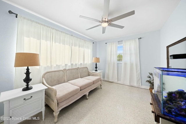 1117 Cheyenne Dr, Indian Harbour Beach, FL 32937 - living area with speckled floor and ceiling fan