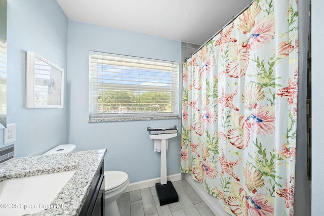 1117 Cheyenne Dr, Indian Harbour Beach, FL 32937 - bathroom with toilet, curtained shower, vanity, baseboards, and wood tiled floor