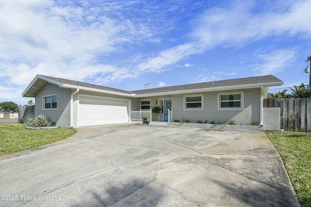 1117 Cheyenne Dr, Indian Harbour Beach, FL 32937 - single story home with concrete driveway, stucco siding, fence, a front yard, and a garage
