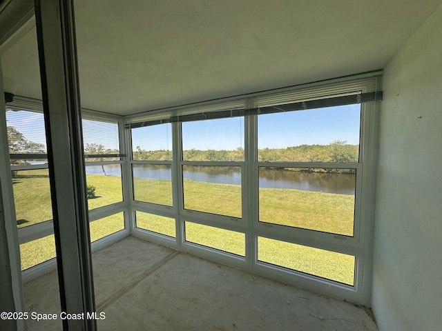 unfurnished sunroom with a water view