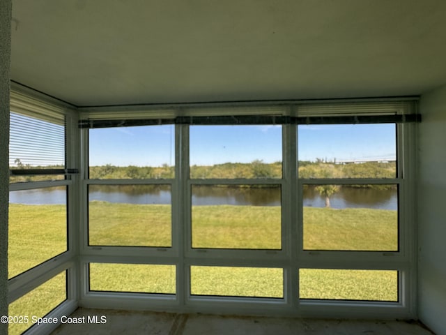 unfurnished sunroom with a water view