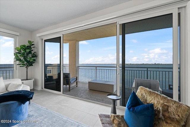 interior space with a water view and tile patterned flooring