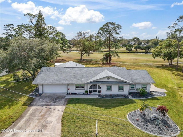 1253 Saint Andrews Dr, Rockledge, FL 32955 - view of front facade featuring a front yard, a shingled roof, a garage, stucco siding, and driveway