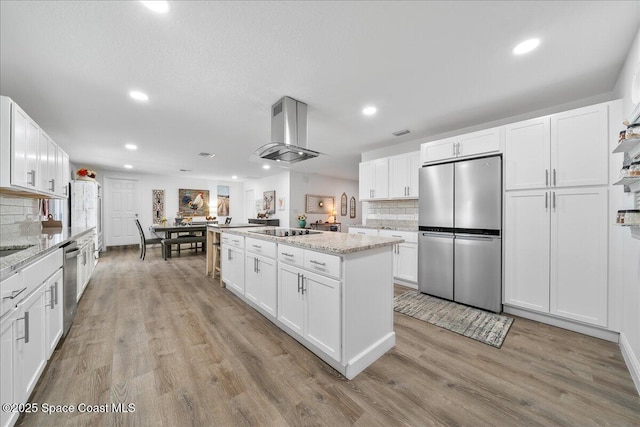 1253 Saint Andrews Dr, Rockledge, FL 32955 - kitchen featuring decorative backsplash, recessed lighting, a kitchen island, and stainless steel appliances